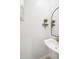 Powder room with white fixtures, decorative mirror, and a plant on a shelf at 29431 N 122Nd Gln, Peoria, AZ 85383