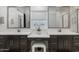 Bright bathroom featuring dual vanities, modern fixtures, and a central makeup station at 29431 N 122Nd Gln, Peoria, AZ 85383