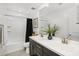 Well-lit bathroom showcasing a double sink vanity, tile flooring, and bathtub at 29431 N 122Nd Gln, Peoria, AZ 85383