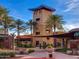 Attractive community center features a tower, palm trees, covered walkway, and desert landscaping at 29431 N 122Nd Gln, Peoria, AZ 85383