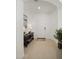 Bright entryway with light tile flooring, white walls, decorative table, and an arched opening at 29431 N 122Nd Gln, Peoria, AZ 85383
