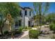 Charming two-story stucco home features a well-manicured front yard with mature trees and a brick walkway at 29431 N 122Nd Gln, Peoria, AZ 85383