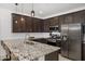 Well-appointed kitchen featuring stainless steel appliances, a large granite island with seating, and ample cabinet space at 29431 N 122Nd Gln, Peoria, AZ 85383