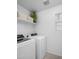 Functional laundry room featuring modern washer and dryer units and ample storage space at 29431 N 122Nd Gln, Peoria, AZ 85383