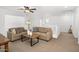 Comfortable seating area with a couch, coffee table, and view of the upstairs hallway at 29431 N 122Nd Gln, Peoria, AZ 85383