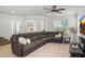 Inviting living room showcasing a comfortable sectional sofa, recessed lighting, and an open layout for modern living at 29431 N 122Nd Gln, Peoria, AZ 85383