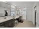Modern main bathroom featuring double sinks, a walk-in shower, and a large mirror at 29431 N 122Nd Gln, Peoria, AZ 85383