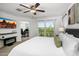 Bright main bedroom with a balcony, a modern fireplace, and view into the office at 29431 N 122Nd Gln, Peoria, AZ 85383