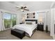 Spacious main bedroom with a balcony, ceiling fan, and two nightstands at 29431 N 122Nd Gln, Peoria, AZ 85383