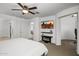 Comfortable bedroom with a flat screen, modern fireplace, and walk in closet at 29431 N 122Nd Gln, Peoria, AZ 85383