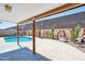 Charming backyard with a covered patio, pool, and mural-decorated wall offers a private and artistic outdoor escape at 3133 E Redwood Ct, Phoenix, AZ 85048