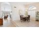 Open dining room features tile flooring, a chandelier, and convenient access to other rooms at 3133 E Redwood Ct, Phoenix, AZ 85048