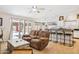 Open living area features tile flooring, a ceiling fan, and access to a bar and the back yard at 3133 E Redwood Ct, Phoenix, AZ 85048