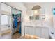 Luxurious bathroom featuring double sinks, walk-in closet, and large mirrors at 3133 E Redwood Ct, Phoenix, AZ 85048