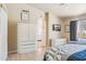 Bright bedroom features ensuite bath, decorative artwork and backyard views at 3133 E Redwood Ct, Phoenix, AZ 85048