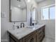 Bathroom features an elegant dark wood vanity with double sinks, marble countertops and modern lighting at 346 W Edgemont Ave, Phoenix, AZ 85003