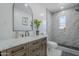 Modern bathroom with a walk-in shower, marble countertops, and a decorative mirror with vanity at 346 W Edgemont Ave, Phoenix, AZ 85003