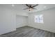 Well-lit bedroom with wood-look floors, a ceiling fan, recessed lighting, and an empty closet at 346 W Edgemont Ave, Phoenix, AZ 85003