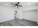 An open doorway leads into a spacious bedroom with gray floors, white walls and a ceiling fan at 346 W Edgemont Ave, Phoenix, AZ 85003