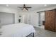 Bedroom boasts a barn door leading to the bathroom, hardwood floors, ceiling fan and large window at 346 W Edgemont Ave, Phoenix, AZ 85003