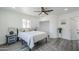 Bright bedroom features a ceiling fan, hardwood floors, and access to bathroom and closet at 346 W Edgemont Ave, Phoenix, AZ 85003