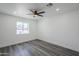 Bright bedroom with laminate flooring, ceiling fan, natural light, and freshly painted walls at 346 W Edgemont Ave, Phoenix, AZ 85003