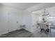 Bright entryway featuring wood-look floors leading to an open dining area and front door at 346 W Edgemont Ave, Phoenix, AZ 85003