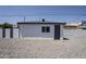 Exterior of building shows neutral paint with a modern paint scheme and a gravel yard at 346 W Edgemont Ave, Phoenix, AZ 85003