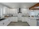 Spacious kitchen offers stainless steel appliances, white cabinetry, hardwood floors and a breakfast bar at 346 W Edgemont Ave, Phoenix, AZ 85003