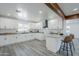 Open kitchen boasts white cabinets, quartz countertops, and views into the dining area at 346 W Edgemont Ave, Phoenix, AZ 85003