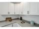 Stylish kitchen detail with white cabinets, quartz countertops, and modern decor accents at 346 W Edgemont Ave, Phoenix, AZ 85003