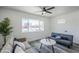 Bright living room featuring modern decor, a ceiling fan, and a large window at 346 W Edgemont Ave, Phoenix, AZ 85003