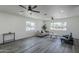 The living room is bright with two large windows and modern ceiling fans at 346 W Edgemont Ave, Phoenix, AZ 85003