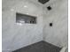 Stunning walk-in shower with black and white accent tiles, marble walls and a rain shower head at 346 W Edgemont Ave, Phoenix, AZ 85003