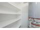 Practical utility space with white shelving and a modern water heater for efficient home maintenance at 346 W Edgemont Ave, Phoenix, AZ 85003
