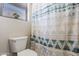 Toilet in bathroom with window and decorative shower curtain at 3534 N 106Th Ln, Avondale, AZ 85392