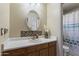 Inviting bathroom with oak vanity, decorative mirror, and a convenient shower at 3534 N 106Th Ln, Avondale, AZ 85392