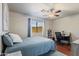 Comfortable bedroom with wood floors, fan and ample natural light from the window at 3534 N 106Th Ln, Avondale, AZ 85392