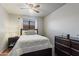 Cozy bedroom with a ceiling fan, comfortable bed, and a dresser for storage at 3534 N 106Th Ln, Avondale, AZ 85392