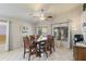 Spacious dining room featuring a table with seating for eight, a ceiling fan and access to the patio at 3534 N 106Th Ln, Avondale, AZ 85392