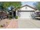 Charming single-story home featuring a two-car garage, desert landscaping, and a cozy covered entrance at 3534 N 106Th Ln, Avondale, AZ 85392