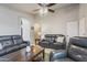 Comfortable living room featuring plush seating, ceiling fan, and a view into the next room at 3534 N 106Th Ln, Avondale, AZ 85392