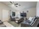 Inviting living room with comfortable seating, a ceiling fan, and a view of the outside through a window at 3534 N 106Th Ln, Avondale, AZ 85392