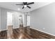 Bedroom with wood-look flooring, ceiling fan, and ensuite bathroom access at 3810 N Maryvale Pkwy # 2020, Phoenix, AZ 85031