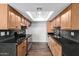 Well-lit kitchen with stainless steel appliances, dark marbled countertops and light wood cabinetry at 3810 N Maryvale Pkwy # 2020, Phoenix, AZ 85031