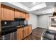 Bright kitchen features dark marbled countertops, light wood cabinets, and stainless appliances at 3810 N Maryvale Pkwy # 2020, Phoenix, AZ 85031