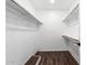 Bright walk-in closet with white walls and multiple clothing racks at 3810 N Maryvale Pkwy # 2020, Phoenix, AZ 85031
