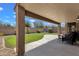 Backyard featuring a covered patio, green grass, and a block wall for privacy at 4101 S Dewdrop Ct, Gilbert, AZ 85297