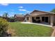 View of the covered patio, grassy backyard, fenced yard, and playground structure at 4101 S Dewdrop Ct, Gilbert, AZ 85297