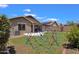 Spacious backyard featuring a colorful play structure, lush lawn, and desert landscaping, perfect for Gathering fun at 4101 S Dewdrop Ct, Gilbert, AZ 85297